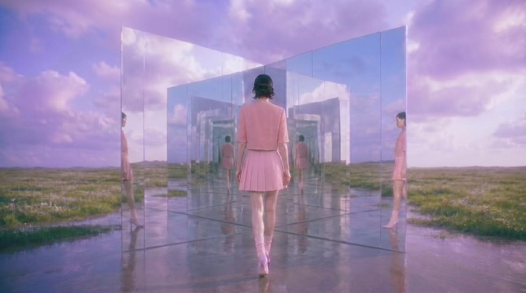 Model walking into a mirrored corridor beneath a violet sky