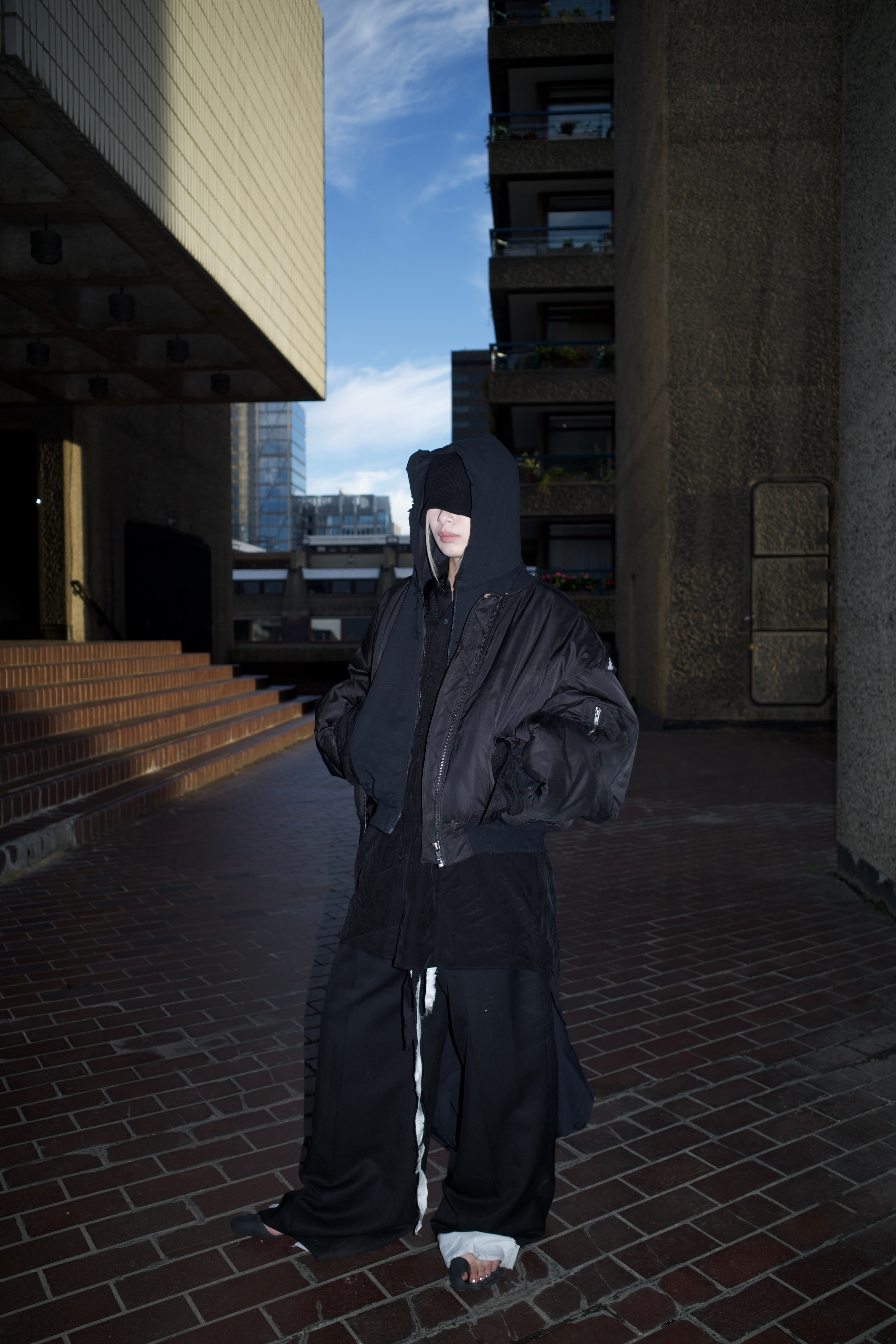 Invisible Armour standing in a concrete passage