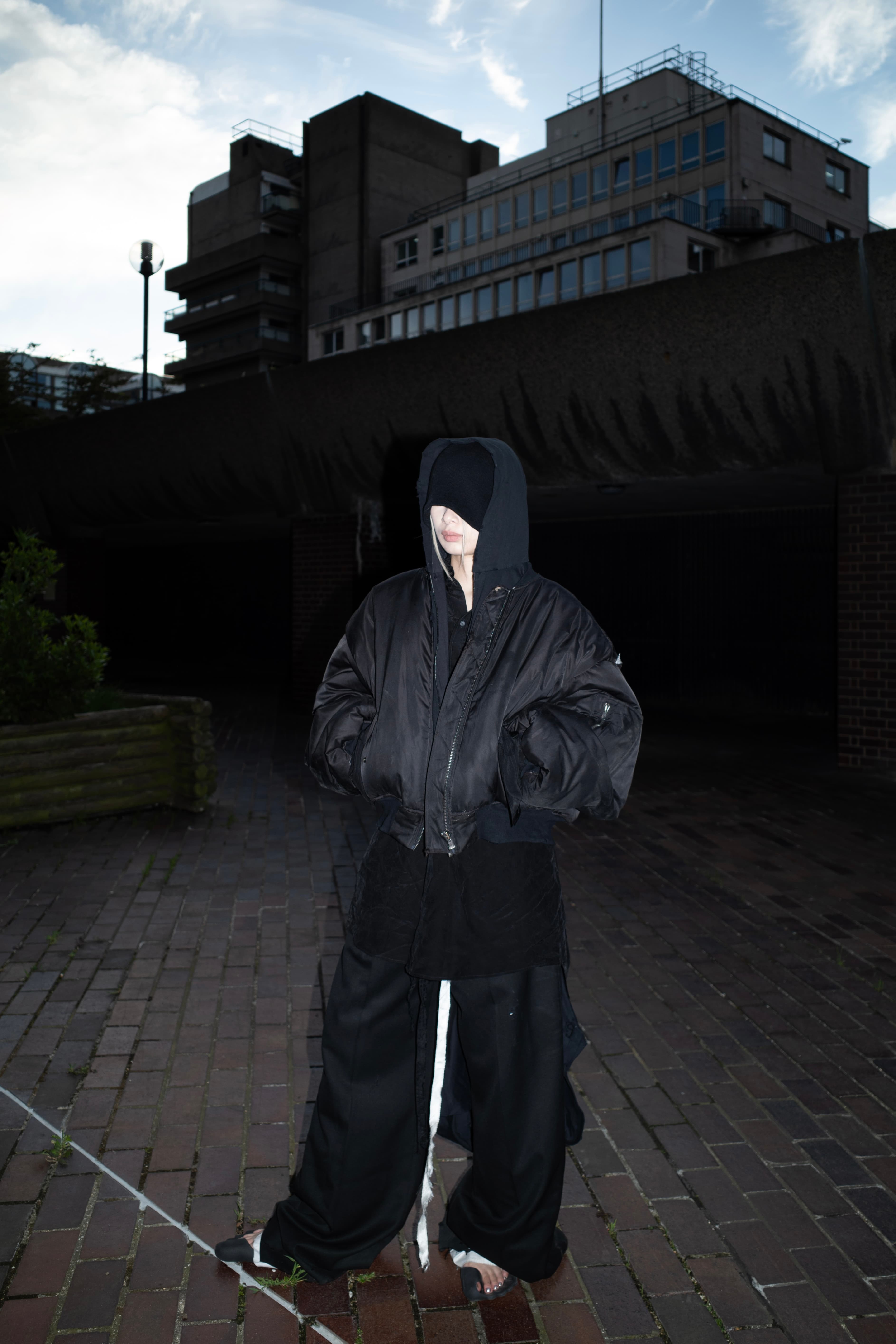 Invisible Armour standing under heavy architecture