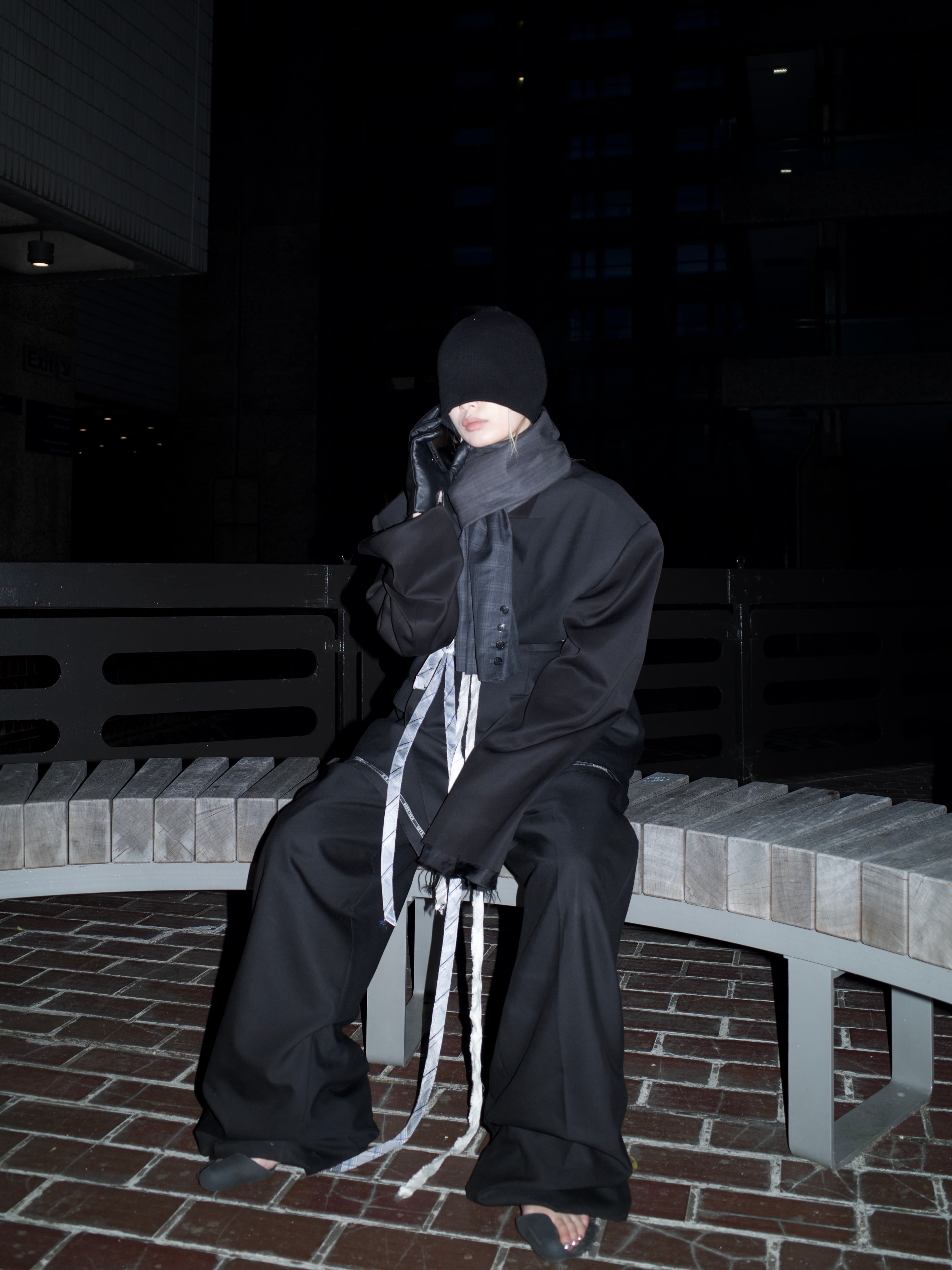 Invisible Armour standing in a dim courtyard