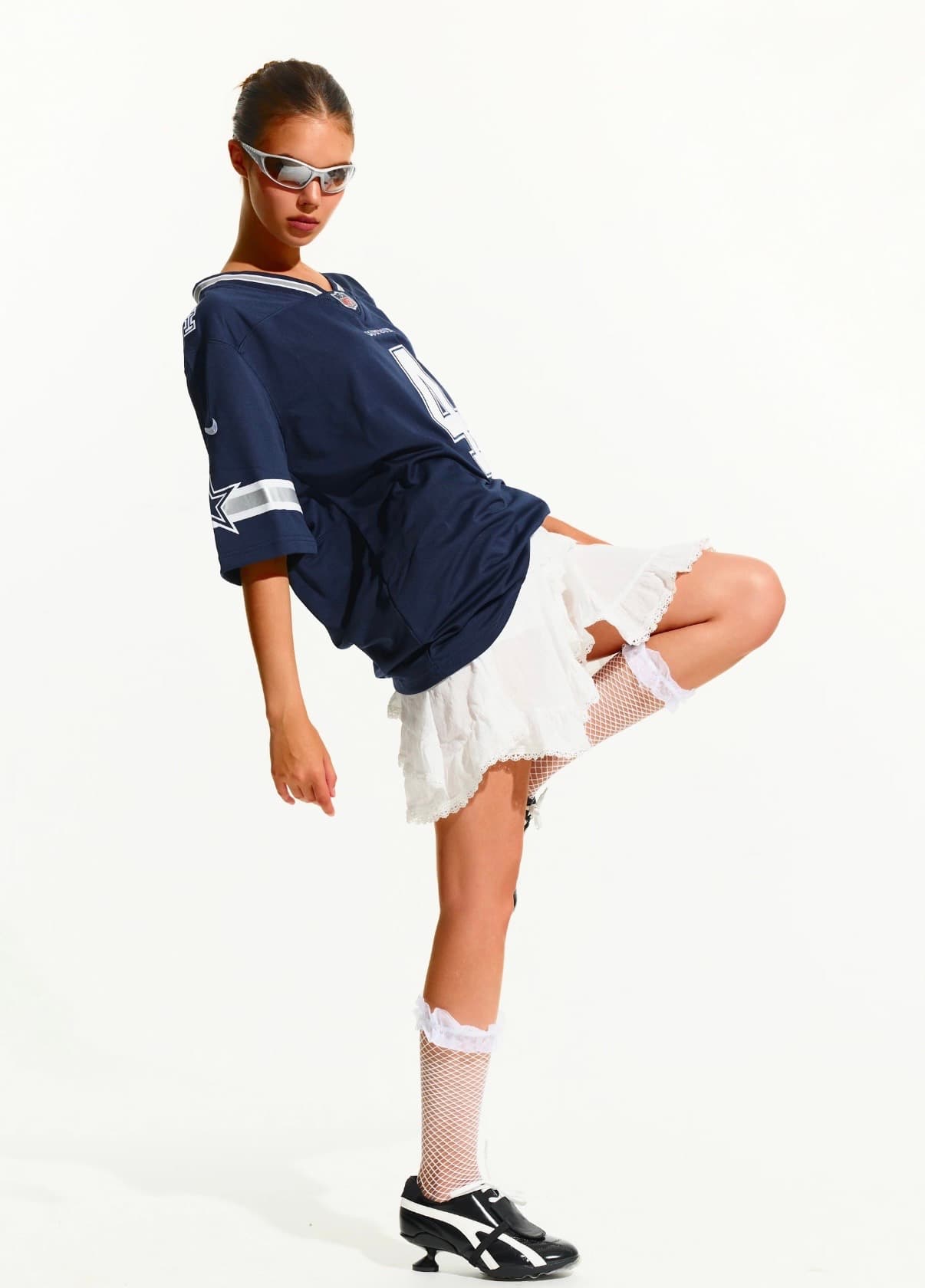 Grace in Motion model balancing in an oversized sports jersey